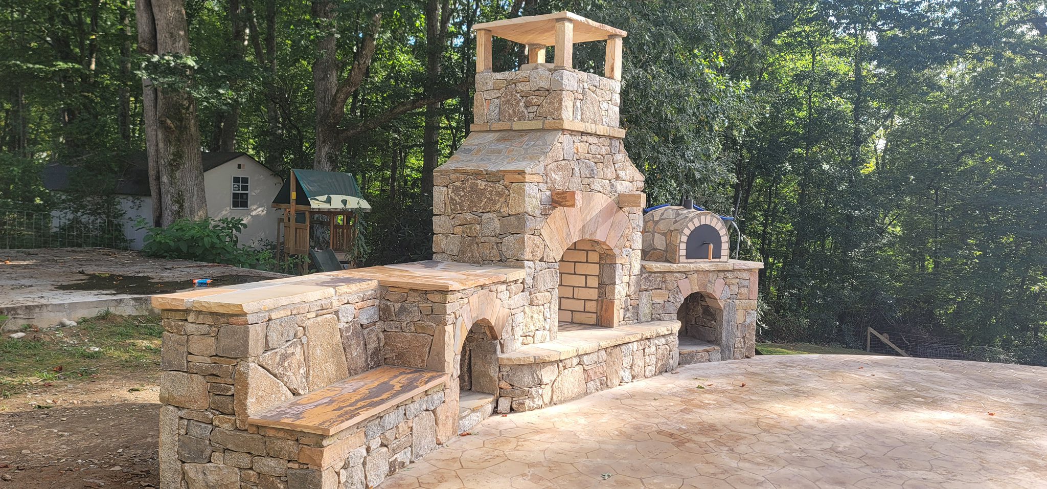 Outdoor stone fireplace and pizza oven